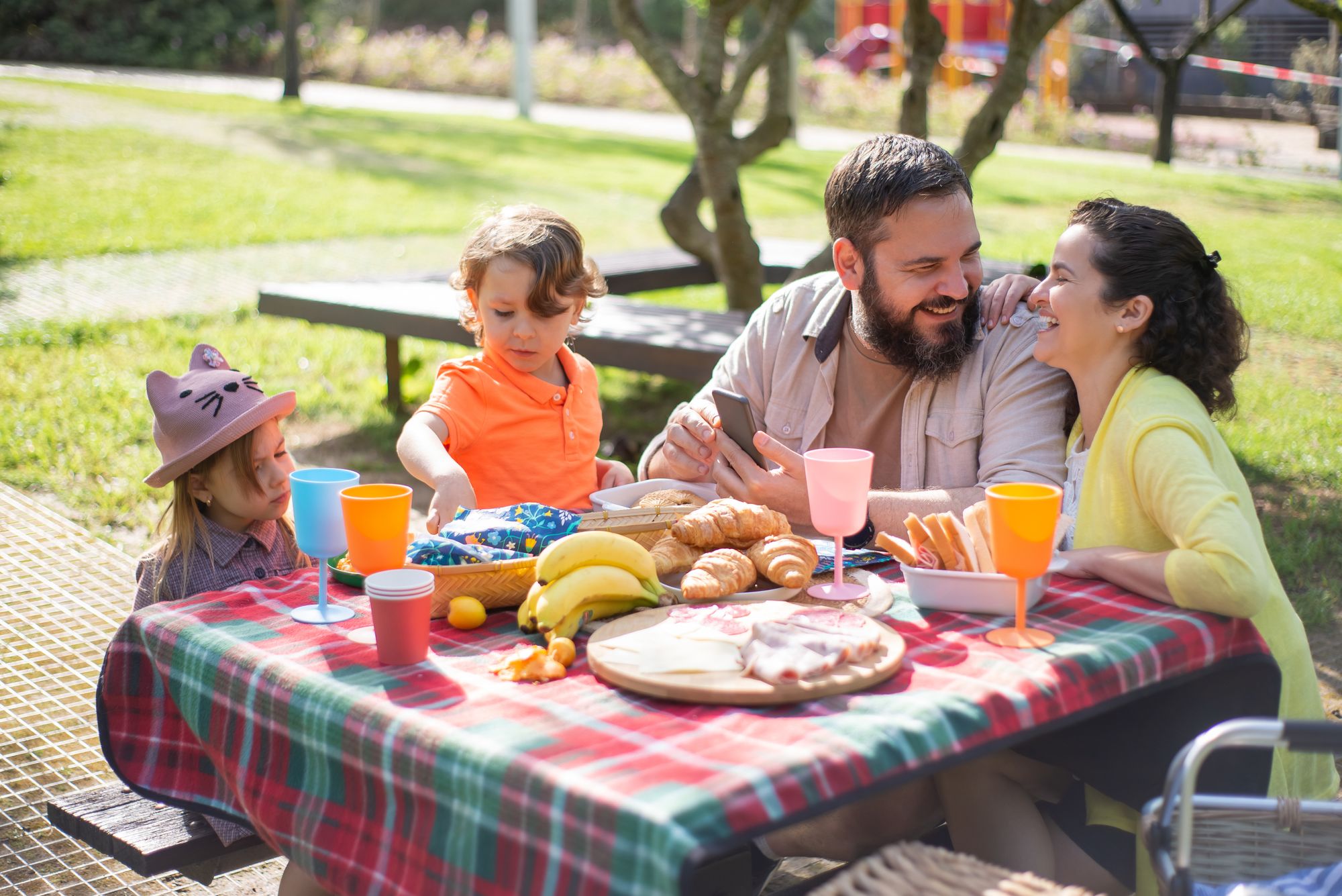 Parents and children sharing a picnic in the park