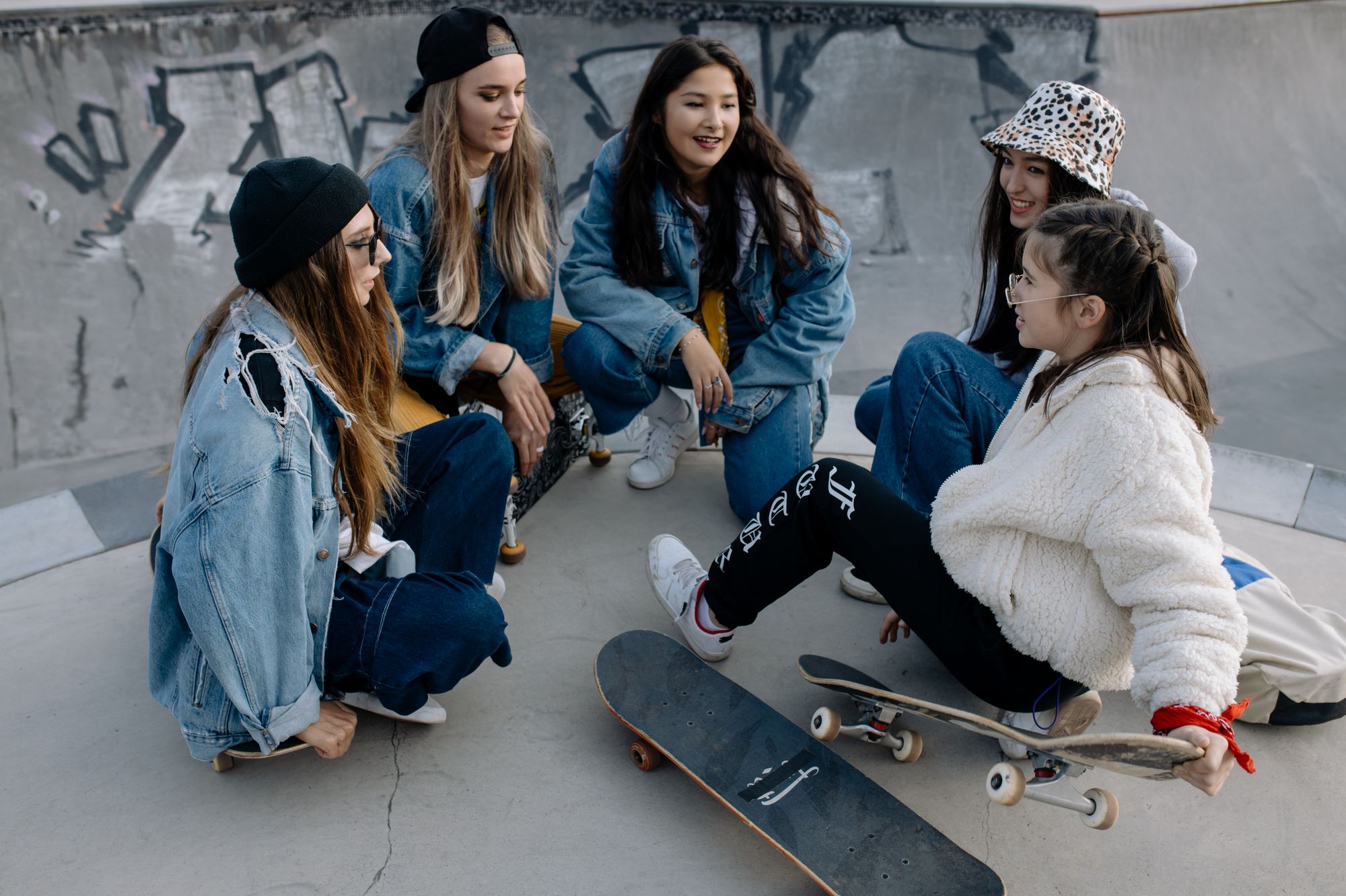 Teen friends talking together at a skatepark